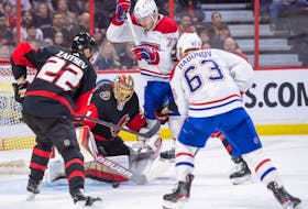Senators goalie Anton Forsberg makes a save in front of Canadiens' Evgenii Dadonov (63) and Kirby Dach (77) in the second period at the Canadian Tire Centre in Ottawa on Saturday, Jan. 28, 2023.