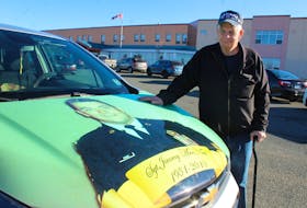 Jimmy MacNeil Sr. stands next to his car which he had customized with a photo of his son Sgt. Jimmy MacNeil on the hood. One time while stopped at a crosswalk to let a man pass, MacNeil said the man saw the picture and stopped, crossed himself and said a prayer before continuing to cross the road. NICOLE SULLIVAN/CAPE BRETON POST