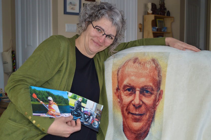 It has been two months since Mary Phalen’s partner, Craig Mackie, received a medically assisted death at their home in Milton Station, P.E.I. Memories of Mackie still fill her heart – and her house – including the pictures she’s holding and a special fleece blanket with his image on it, which was given to her by a friend at Christmas. Dave Stewart • The Guardian