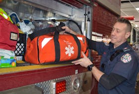 Johnny Becerra, one of Charlottetown’s full-time firefighters, puts gear away after checking it at Station 1 on Kent Street on Jan. 30. Dave Stewart • The Guardian