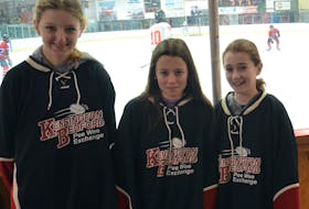Three generations of participants and supporters of the Eric Jessome Memorial Kensington, P.E.I.-Bedford, Que., Under-13 Hockey Exchange were honoured at Credit Union Centre on Jan. 28. Representing those three generations are this year’s participants, from left: Makenzi Verhulp, Cali Bernard and Peyton Gill. Jason Simmonds • Journal Pioneer