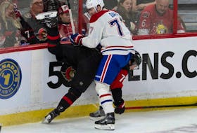 Montreal Canadiens centre Kirby Dach collides with Ottawa Senators defenceman Thomas Chabot along the boards during second period on Jan. 28, 2023, in Ottawa.