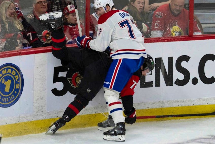 Montreal Canadiens centre Kirby Dach collides with Ottawa Senators defenceman Thomas Chabot along the boards during second period on Jan. 28, 2023, in Ottawa.