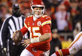 Patrick Mahomes #15 of the Kansas City Chiefs looks to pass against the Cincinnati Bengals during the third quarter in the AFC Championship Game at GEHA Field at Arrowhead Stadium on Sunday. 
