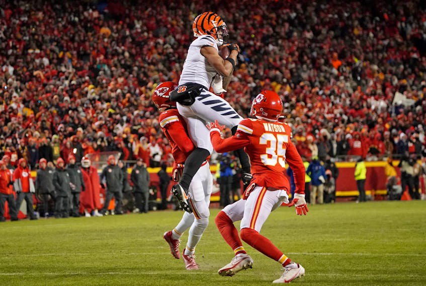 Cincinnati Bengals wide receiver Ja'Marr Chase (1) makes a catch against Kansas City Chiefs safety Bryan Cook (6) and cornerback Jaylen Watson (35) during the third quarter of the AFC Championship game at GEHA Field at Arrowhead Stadium in Kansas City, Mo., on Sunday, Jan. 29, 2023. - Denny Medley / USA TODAY Sports via Reuters