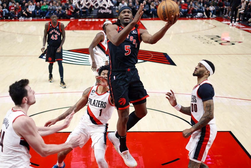 Raptors’ Precious Achiuwa drives to the basket past Trail Blazers shooting guard Anfernee Simons on Saturday in Portland. Achiuwa has another good game in the Raptors’ victory.