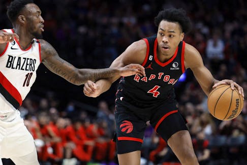 Toronto Raptors small forward Scottie Barnes (4) dribbles the ball while defended by  Portland Trail Blazers small forward Nassir Little (10) during the second half at Moda Center