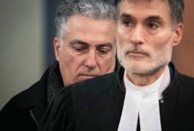 Fadi Hamdan, left, walks behind his lawyer, François Taddeo, at the Montreal courthouse on Tues., Jan. 31.