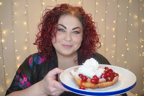 Chef Ilona Daniel displays the cherry-slathered funnel cake she whipped up using a box of store-bought complete pancake mix. Contributed photo