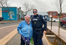 Eva Turple is shown in this town of Kentville photo with Kentville police officer Const. Kara Mason. Turple, a well-known figure in the town, passed away Tuesday at the age of 67. - Contributed