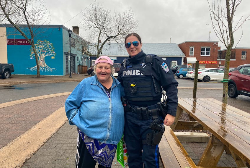 Eva Turple is shown in this town of Kentville photo with Kentville police officer Const. Kara Mason. Turple, a well-known figure in the town, passed away Tuesday at the age of 67. - Contributed
