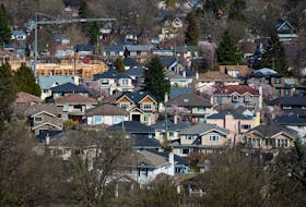 A condo building is seen under construction surrounded by houses in Vancouver, B.C., on Friday March 30, 2018. Canada's banking regulator is expected to make an announcement regarding the interest rate used in a key stress test for uninsured mortgages this morning. THE CANADIAN PRESS/