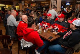 Hockey fans stop in at the Midtown Tavern before the IIHF World Junior Hockey Championship semifinal game between Canada and the United States on Wednesday.  Hockey fans have filled bars and restaurants in what is usually a slow time of year. - Ryan Taplin / The Chronicle Herald