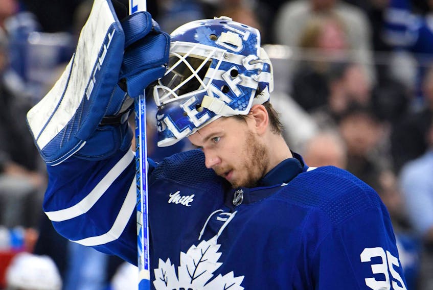 Toronto Maple Leafs goalie Ilya Samsonov adjusts his mask before play resumes against the St. Louis Blues in the second period at Scotiabank Arena. 