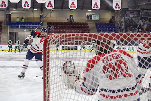 Acadia Axemen forward Liam Kidney warms up goalie Brayden Peters before the team's Sept. 29 pre-season game with the UPEI Panthers. Kidney is a second-year player at Acadia while Peters is in his rookie campaign.