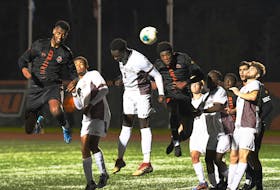 Cape Breton Capers' Muad Mohamoud, left, heads in the game winner in a hard-fought 2-1 battle with the Mount Allison Mounties in AUS men's soccer action Saturday night at Ness Timmons Field. CONTRIBUTED/VAUGHAN MERCHANT, CBU ATHLETICS