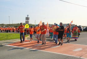 A sea of orange T-shirts completed a healing walk around Maupeltuewey Kina'matno'kuom (Membertou School) led by community drummers to honour those lost to the residential school system. MITCHELL FERGUSON/CAPE BRETON POST