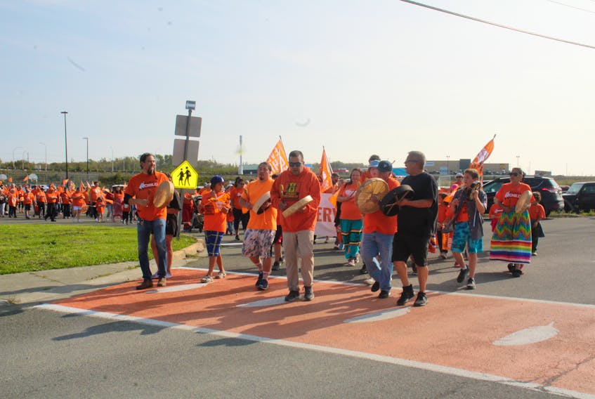 A sea of orange T-shirts completed a healing walk around Maupeltuewey Kina'matno'kuom (Membertou School) led by community drummers to honour those lost to the residential school system. MITCHELL FERGUSON/CAPE BRETON POST