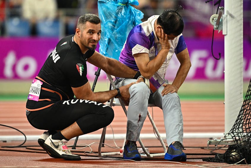 By Martin Quin Pollard and Dylan Martinez HANGZHOU, China (Reuters) - An athletics official suffered a broken leg and serious bleeding after being hit by a misthrown hammer in the Asian Games in