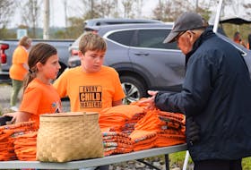 Lydia Turnbull, 10, and Jaxon Mitchell, 10, from Glooscap, volunteer to work the T-shirt table at the National Day for Truth and Reconciliation at Glooscap Landing on Sept. 30. Shirts were available by free-will offering.
 Aimee Alden • Special to the Valley Journal-Advertiser