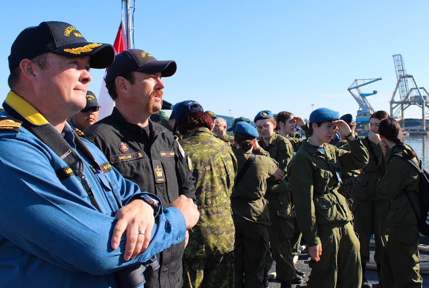 HMCS Glace Bay commanding officer Paul Morrison (left) watches with others aboard the ship during a demonstration in the Sydney Harbour on Friday. The naval vessel took about three dozen guests for a four-hour sail through the harbour as part of an armed forces recruiting tour across Canada. LUKE DYMENT/CAPE BRETON POST
