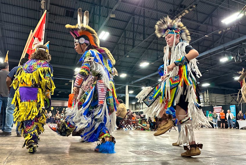 Logan Lewis, centre, the male head dancer, and Taite Wooldridge, the junior head dancer, showcase their dances during the Grand Entry at the inaugural Treaty Day Mawio’mi in Charlottetown on Oct. 1. Thinh Nguyen • The Guardian