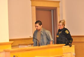 Evan Long is escorted into a Corner Brook courtroom for an appearance on Thursday, March 16. Long is charged with attempted murder. - Diane Crocker/SaltWire Network