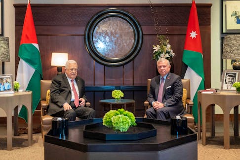 Jordan's King Abdullah II meets with Palestinian President Mahmoud Abbas in Amman, Jordan October 12, 2023. Royal Hashemite Court/Handout via Reuters