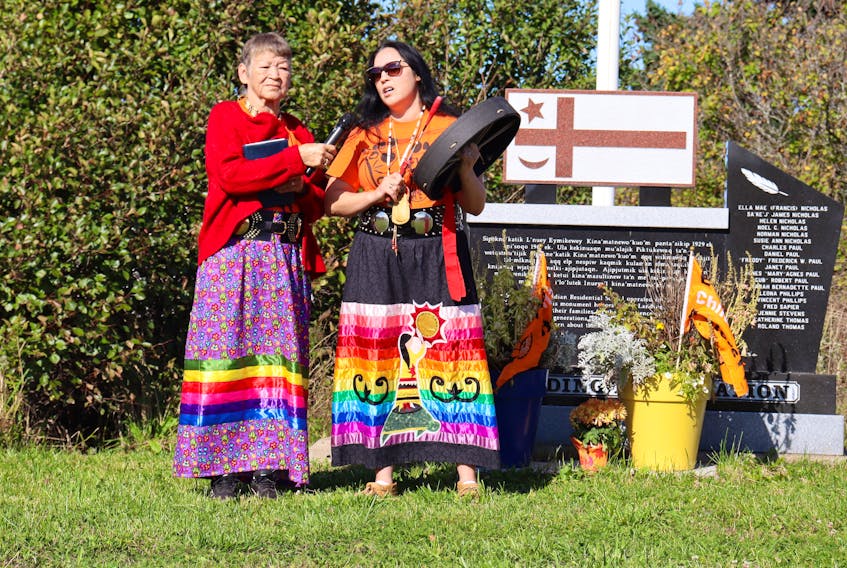 Mary Hatfield, left, is seen holding the microphone for her daughter, Michelle Peters who sang The Turtle and the Whale during Pictou Landing's Truth and Reconciliation events. ANGELA CAPOBIANCO