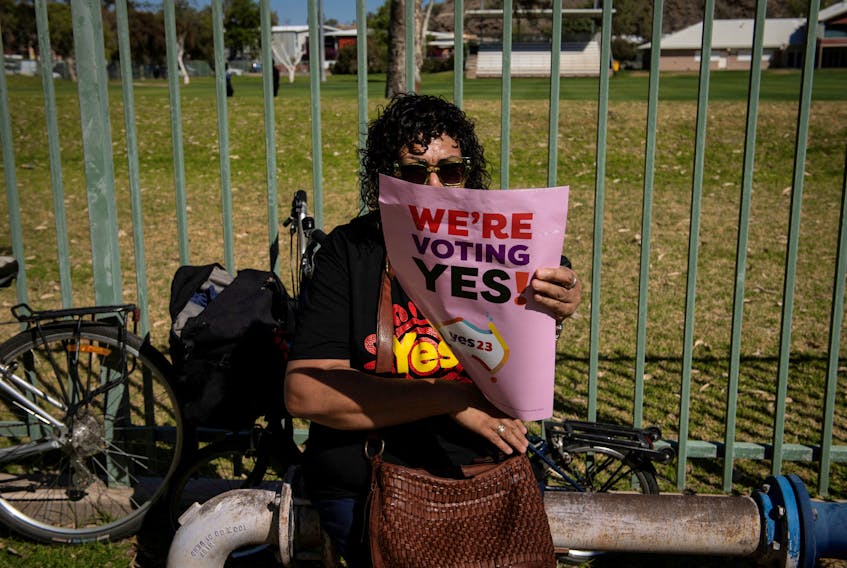 FILE PHOTO: A woman holds up a 'Yes' supporting sign during the 'Walk for Yes', hosted by the Yes23 campaign for Australia's upcoming referendum on Indigenous issues, at the Todd River in Alice Springs, Australia, September 17, 2023.   REUTERS/Jaimi Joy