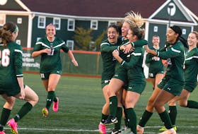 Grace Hannaford (centre) is swarmed by her teammates after scoring the early go-ahead goal in the Cape Breton Capers' 1-0 win over the Memorial Sea-Hawks Friday evening at Ness Timmons Field. The Capers improve to 8-1-0 (win-loss-tie) with their sixth straight win. VAUGHAN MERCHANT/CBU ATHLETICS