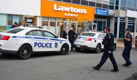 Halifax Regional Police officers attend the scene of a stabbing on Portland Street in downtown Dartmouth on Monday afternoon. A man was taken to hospital with life-threatening injuries and a suspect was taken into custody.