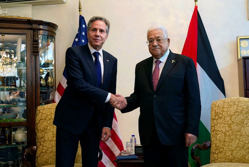 U.S. Secretary of State Antony Blinken shake hands with Palestinian President Mahmoud Abbas, in Amman, Jordan, Friday Oct. 13, 2023. Jacquelyn Martin/Pool via REUTERS/File Photo