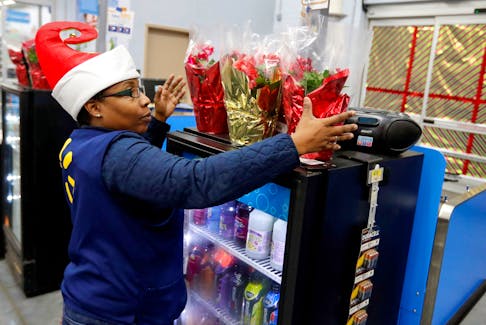 An employee checks on a Christmas display at a Walmart store in Chicago, Illinois, U.S. November 23, 2016. REUTERS/Kamil Krzaczynski/File photo