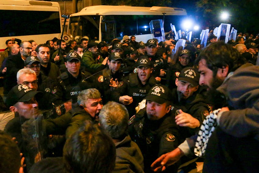 Pro-Palestinian demonstrators argue with Turkish police during a protest, after hundreds of Palestinians were killed in a blast at Al-Ahli hospital in Gaza that Israeli and Palestinian officials blamed on each other, in front of the Israeli Embassy in Ankara, Turkey October 18, 2023. Reuters could not immediately verify the claims nor the death toll. 