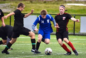 Justus Mills of the Sydney Academy Wildcats, middle, breaks through a pair of defenders including Tom Wilkens, left, and Maddox Devereaux, both of the Glace Bay Panthers, during Cape Breton High School Soccer League action at Open Hearth Park in Sydney on Wednesday. Sydney Academy won the game 9-0. JEREMY FRASER/CAPE BRETON POST.