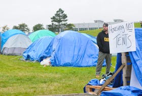 The homeless protest continues this Thanksgiving weekend with the makeshift “tent city” set-up on Prince Philip Drive on the green space near the College of North Atlantic. And on Friday, October 6, 2023, some protestors have set-up camp on the Confederation Building east lawn across the street from their tent friends. Above, a lone protestor is shown by some of the tents as he takes in the events going on.
-Photo by Joe Gibbons/The Telegram