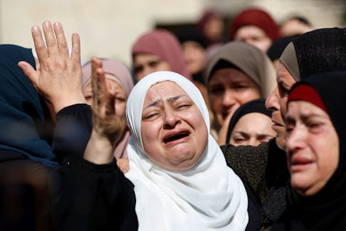 Mourners react during the funeral of a Palestinian who was killed by Israeli forces, near Ramallah in the Israeli-occupied West Bank October 19, 2023.