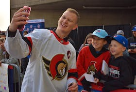 Ottawa Senators captain Brady Tkachuk, left, takes a selfie with 10-year-old Cohen Lynk of Glace Bay, centre, and seven-year-old Kaleb Chisholm of Mira prior to the NHL team’s morning skate at Centre 200 in Sydney. The Senators were in Cape Breton to play the Florida Panthers in NHL pre-season action on Sunday. Tkachuk did not play in the game due to an injury, but made the trip with the team. For more coverage of Kraft Hockeyville, visit saltwire.com/cape-breton. JEREMY FRASER/CAPE BRETON POST
