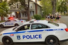 A group of young people make there way up a quiet Preston Street Sunday evening. Halifax police broke up a street party in the area, near Dalhousie University, earlier in the day. - Andrew Rankin