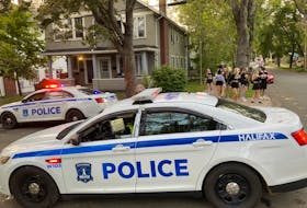A group of young people make there way up a quiet Preston Street Sunday evening. Halifax police broke up a street party in the area, near Dalhousie University, earlier in the day. - Andrew Rankin