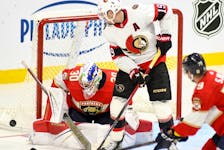 Ottawa Senators forward Drake Batherson (19) deflects a shot in front of Florida Panthers goaltender Spencer Knight during third period NHL preseason hockey action in Sydney, N.S., Sunday, Oct. 1, 2023.