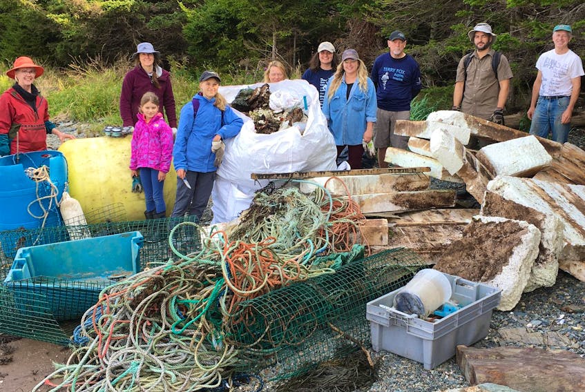 Katie McTiernan, centre, with glasses, and Terry Fox's brother Fred Fox, with dark ball cap, volunteered with others to pick up garbage on islands near St. George.