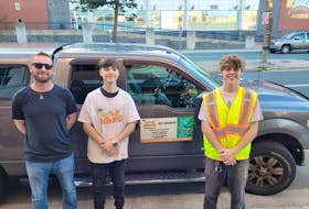 Newfoundland Embassy co-owner Niall Hickey (left) poses with two of the young entrepreneurs behind The Scrub Squad — Jack Boland (centre) and Jacob Sheppard — after a recent successful graffiti removal job for the business. Facebook photo