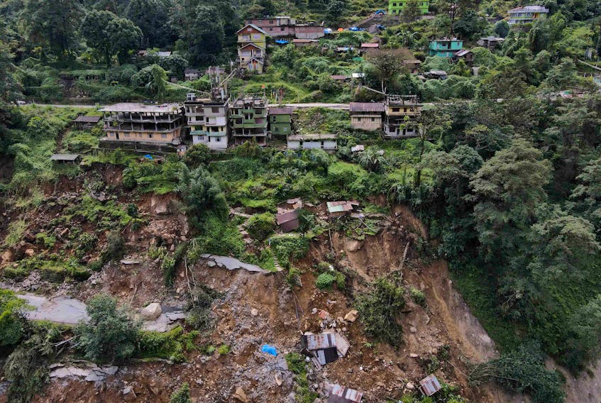 A drone view of damaged roads and houses that were washed away by flash floods in Naga-Namgor village, Sikkim, India, October 10, 2023.