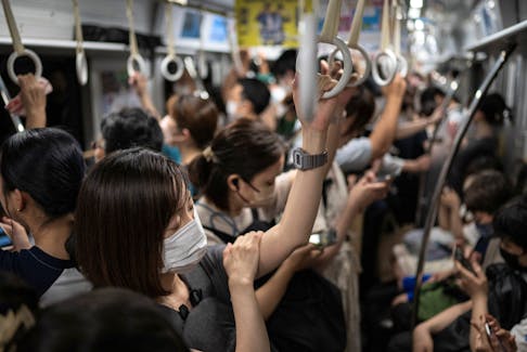 People travel on the subway in Fukuoka, Japan, July 13, 2023.