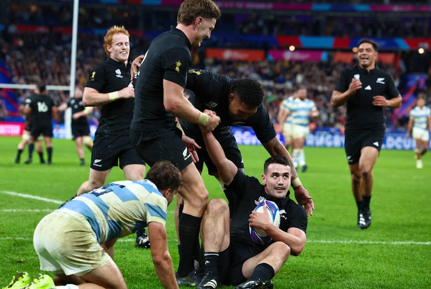 Rugby Union - Rugby World Cup 2023 - Semi Final - Argentina v New Zealand - Stade de France, Saint-Denis, France - October 20, 2023 New Zealand's Will Jordan celebrates scoring their seventh try and completing his hat-trick with teammates