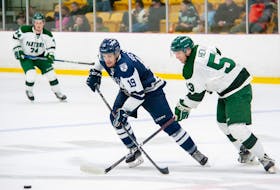 The UPEI Panthers’ Kurtis Henry, 53, and St. Francis Xavier X-Men’s Jacob Stewart, 19, race for the puck in an Atlantic University Sport (AUS) Men’s Hockey Conference game at MacLauchlan Arena in Charlottetown on Oct. 21. The X-Men won the contest 6-3. Janessa Vanden Broek/UPEI Athletics • Special to The Guardian