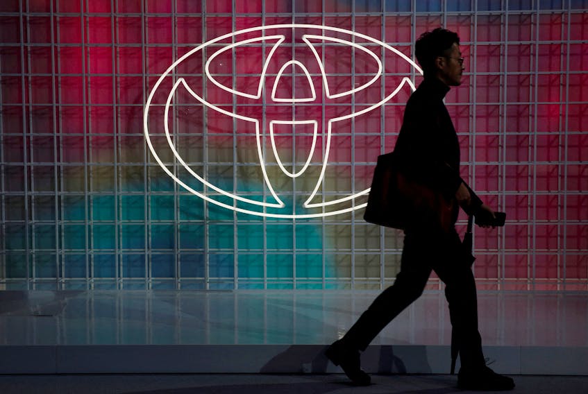 A man walks past a Toyota logo at the Tokyo Motor Show, in Tokyo, Japan October 24, 2019.