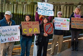 Environmental activists hold signs at an Ecology Action Centre press conference by the water near the Queen's Marque on Tuesday, Oct. 24, 2023. The Ecology Action Centre is calling on the provincial government to fully implement the Coastal Protection Act.
Ryan Taplin - The Chronicle Herald